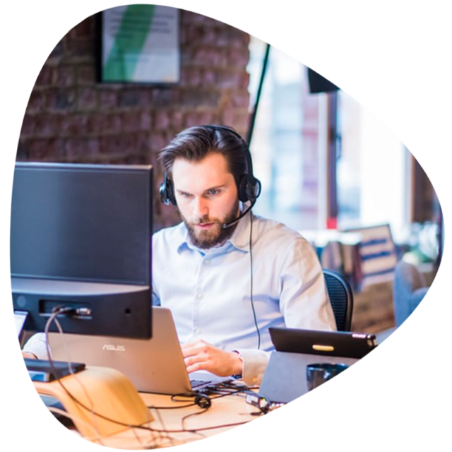Man at computer station with headset